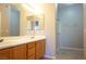 Well-lit bathroom with double sinks, spacious vanity, and glass-enclosed shower stall at 3400 Cabana Dr # 2010, Las Vegas, NV 89122
