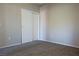 Neutral carpeted bedroom features a closet with sliding doors, base trim, and electrical outlets at 3400 Cabana Dr # 2010, Las Vegas, NV 89122