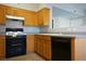 Functional kitchen with black appliances, wood cabinets, and laminate countertop at 3400 Cabana Dr # 2010, Las Vegas, NV 89122