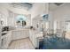Bright kitchen with white cabinetry, tiled floors, and a dining table next to the double doors at 3550 Bay Sands Dr # 1003, Laughlin, NV 89029