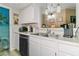 Bright kitchen features white cabinets, stainless steel appliances, and a double sink with modern fixtures at 3550 Bay Sands Dr # 1003, Laughlin, NV 89029
