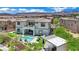 Aerial showing rear of home, pool, outdoor kitchen, manicured lawns and mature trees at 362 Port Reggio St, Las Vegas, NV 89138
