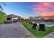 Relaxing backyard space featuring a covered outdoor kitchen, lounge chairs and inviting pool area at 362 Port Reggio St, Las Vegas, NV 89138