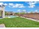 Lush backyard with green lawn, refreshing pool, and tranquil landscaping perfect for outdoor entertaining at 362 Port Reggio St, Las Vegas, NV 89138