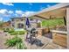 Backyard featuring an outdoor kitchen, BBQ grill, and landscaped areas for enjoyable outdoor living at 362 Port Reggio St, Las Vegas, NV 89138