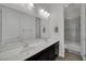 Bathroom with a double sink vanity, large mirror, and tiled shower at 362 Port Reggio St, Las Vegas, NV 89138