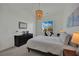 Bright bedroom with a large window, modern light fixture, and sleek black dresser at 362 Port Reggio St, Las Vegas, NV 89138