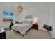 Bright bedroom featuring a large window, exercise bike, and decorative chandelier at 362 Port Reggio St, Las Vegas, NV 89138