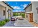 Charming courtyard with stone fireplace, stylish seating, and landscaped surroundings for outdoor relaxation at 362 Port Reggio St, Las Vegas, NV 89138