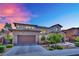 Charming two-story home featuring a stone-accented facade, landscaped yard and a paver driveway at 362 Port Reggio St, Las Vegas, NV 89138