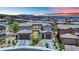 Stunning two-story home with a three-car garage and manicured landscaping, set against a vibrant sunset backdrop at 362 Port Reggio St, Las Vegas, NV 89138