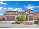 Elegant two-story home with a three-car garage, accented by stone details and landscaped garden at 362 Port Reggio St, Las Vegas, NV 89138