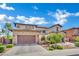 Well-appointed two-story home features a three-car garage, stone accents, and meticulously maintained landscaping at 362 Port Reggio St, Las Vegas, NV 89138