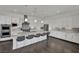 Well-lit kitchen with a spacious island featuring seating, stainless steel appliances, and pristine white cabinets at 362 Port Reggio St, Las Vegas, NV 89138