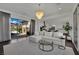 Bright living room featuring a plush sofa, stylish decor, and access to a charming outdoor patio at 362 Port Reggio St, Las Vegas, NV 89138