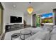 Modern living room featuring stylish decor, a large TV, and seamless access to the outdoor space at 362 Port Reggio St, Las Vegas, NV 89138