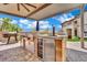 Outdoor kitchen featuring modern appliances, a beer tap, and ample countertop space for outdoor entertaining at 362 Port Reggio St, Las Vegas, NV 89138