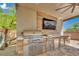 Outdoor kitchen featuring a built-in grill, stainless steel storage, and modern finishes at 362 Port Reggio St, Las Vegas, NV 89138