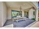 Covered patio with sleek dining set, elegant chandelier, and backyard access for outdoor enjoyment at 362 Port Reggio St, Las Vegas, NV 89138