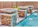 Close-up of a pool with decorative fountains and a brick wall backdrop, adding a touch of elegance at 362 Port Reggio St, Las Vegas, NV 89138