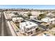Aerial shot featuring several townhomes with carports, a parking lot, and a view of the city in the distance at 3683 Villa Knolls East Dr, Las Vegas, NV 89120