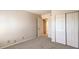 This bedroom features neutral carpeting, a closet with bi-fold doors, and an open door to the rest of the property at 3683 Villa Knolls East Dr, Las Vegas, NV 89120