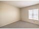 Cozy bedroom with neutral carpet, window, and neutral walls at 3683 Villa Knolls East Dr, Las Vegas, NV 89120