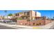 This residential complex is located near a brick privacy wall with signage indicating its name: Tropicana Villas at 3683 Villa Knolls East Dr, Las Vegas, NV 89120