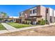 Townhome exterior with a small front yard, a walkway, and an assigned parking spot, set under a clear, blue sky at 3683 Villa Knolls East Dr, Las Vegas, NV 89120