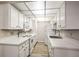 Bright kitchen with white cabinets and quartz countertops and plank flooring at 3683 Villa Knolls East Dr, Las Vegas, NV 89120