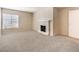 Spacious living room with fireplace, neutral carpet, and ample natural light at 3683 Villa Knolls East Dr, Las Vegas, NV 89120