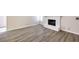 Bright living room with vinyl floors featuring a white painted brick fireplace at 3683 Villa Knolls East Dr, Las Vegas, NV 89120