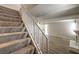 Carpeted staircase with white railings leading to an open-concept living space at 3683 Villa Knolls East Dr, Las Vegas, NV 89120