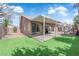 The backyard features a covered patio, well-maintained landscaping, and a playset for outdoor enjoyment at 3905 Blairmoor St, North Las Vegas, NV 89032