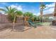 Spacious backyard with lush landscaping, a playset, covered patio, and a built-in grill, perfect for entertaining at 3905 Blairmoor St, North Las Vegas, NV 89032