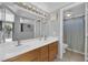 Bathroom features a double sink vanity, tile floors, and a shower-tub combo with a curtain at 3905 Blairmoor St, North Las Vegas, NV 89032