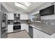 Well-equipped kitchen features stainless steel appliances, grey countertops, backsplash, and a bright window at 3905 Blairmoor St, North Las Vegas, NV 89032