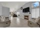 Spacious living room with a fireplace, TV, and dining area, offering ample space for relaxation and entertainment at 3905 Blairmoor St, North Las Vegas, NV 89032