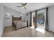 Bright main bedroom with wood floor, ceiling fan, access to the backyard, and custom reading lamps at 3905 Blairmoor St, North Las Vegas, NV 89032