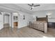 Open main bedroom featuring wood floors, modern ceiling fan, and a pass through to a full bathroom at 3905 Blairmoor St, North Las Vegas, NV 89032