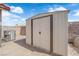 Outdoor storage shed with a double door, providing ample space for tools and equipment at 3905 Blairmoor St, North Las Vegas, NV 89032