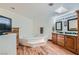 Bright bathroom with a large soaking tub, wooden cabinets, double sinks, and hardwood-style flooring at 4075 E Oquendo Rd, Las Vegas, NV 89120