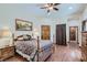 Cozy bedroom with hardwood floors, wood furniture, and ensuite bathroom at 4075 E Oquendo Rd, Las Vegas, NV 89120