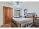 A comfortable bedroom with a wooden bed frame, unique window, and decorative bear-themed bedding at 4075 E Oquendo Rd, Las Vegas, NV 89120