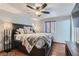 A spacious bedroom featuring a dark wood bed frame with a ceiling fan and a television at 4075 E Oquendo Rd, Las Vegas, NV 89120