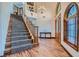 Grand foyer with staircase, arched windows, hardwood floors, and soaring ceilings at 4075 E Oquendo Rd, Las Vegas, NV 89120