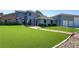 Charming two-story home with well manicured artificial turf, long driveway, and lush landscaping at 4075 E Oquendo Rd, Las Vegas, NV 89120