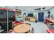 Spacious garage with ample storage, a work area, and an abundance of natural light at 4075 E Oquendo Rd, Las Vegas, NV 89120