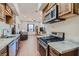 Open kitchen with stainless steel appliances, granite counters, and wood cabinets at 4075 E Oquendo Rd, Las Vegas, NV 89120