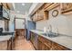 Well-lit kitchen featuring stainless steel appliances, granite countertops, and custom wood cabinetry at 4075 E Oquendo Rd, Las Vegas, NV 89120
